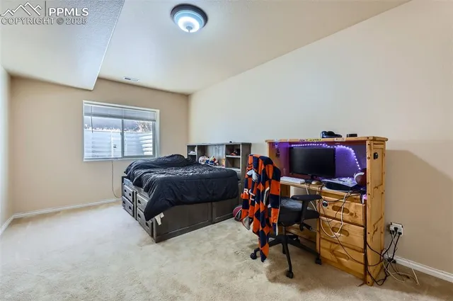a bedroom with a bed and a desk
