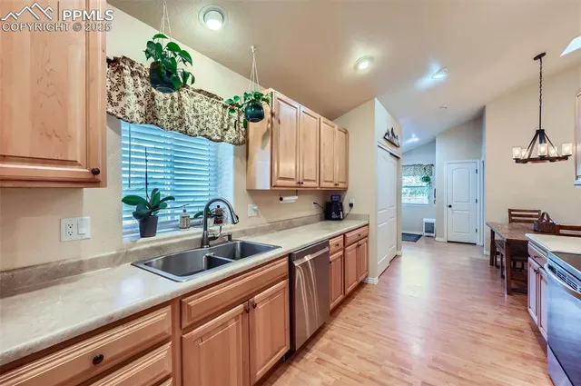 a kitchen with lots of counter space and wooden floor