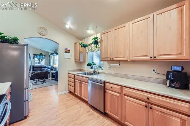 a kitchen with stainless steel appliances granite countertop a stove a sink and a refrigerator
