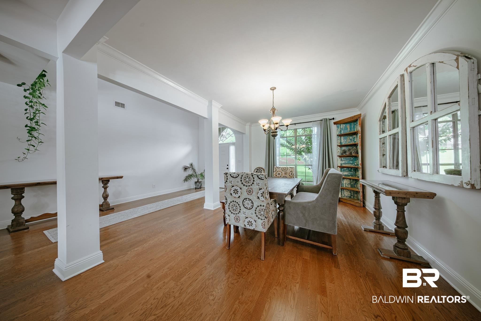 8421 Weatherford Court Daphne, AL 36527 - Photo 10 of 36 Dining room featuring ornamental molding, a chandelier, and wood finished floors