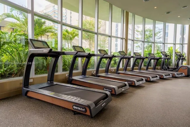 a bedroom with furniture and large windows