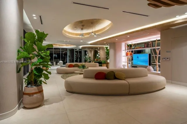 a living room with furniture and a potted plant