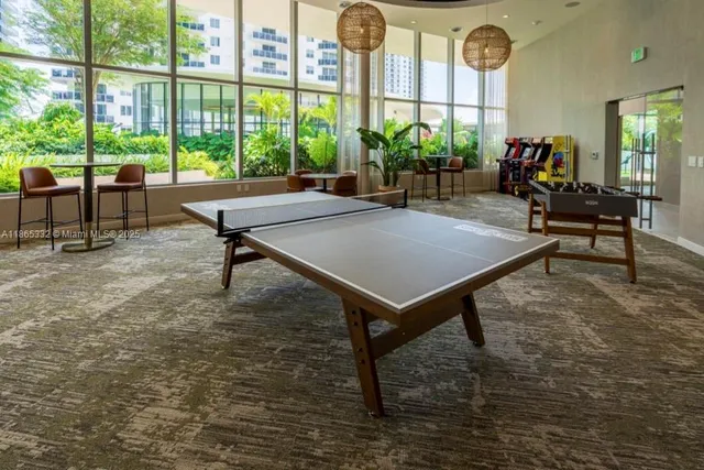 a living room with furniture a table and a large window