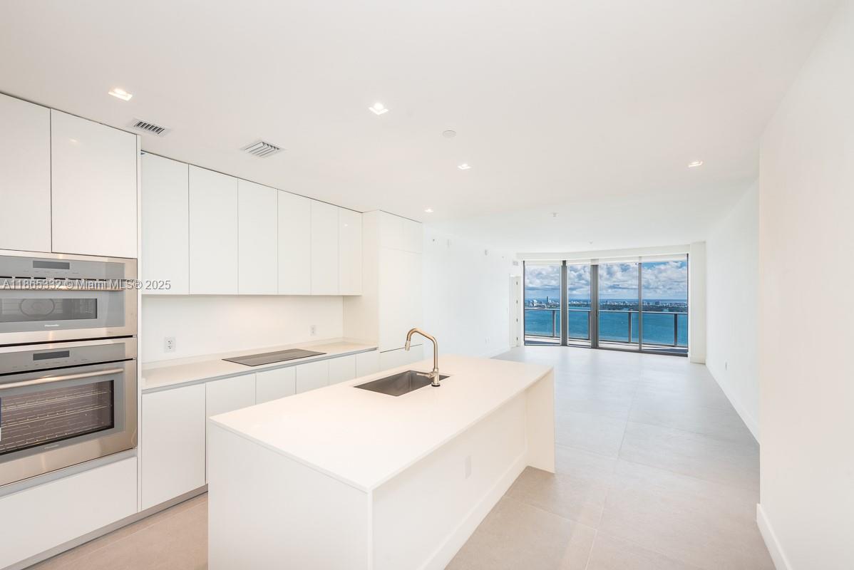 700 Northeast 24th Street, Unit 4303 Miami, FL 33137 - Photo 5 of 41 a kitchen with stainless steel appliances a sink stove and cabinets