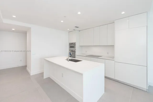 a kitchen with a sink stove and refrigerator