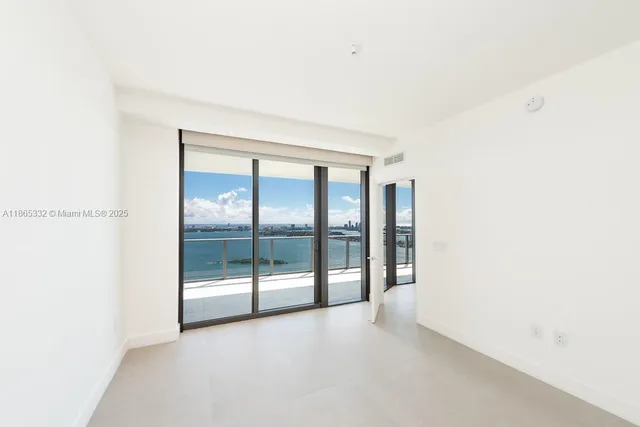 a view of an empty room with glass door