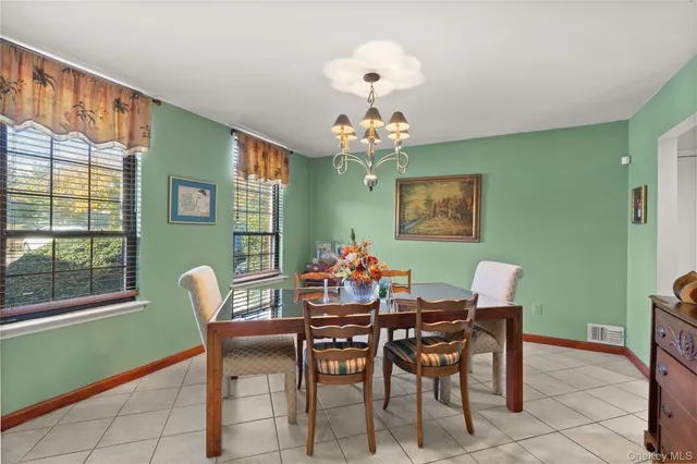 a view of a dining room with furniture and a large window