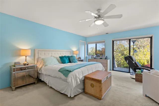 a bedroom with a bed and large window