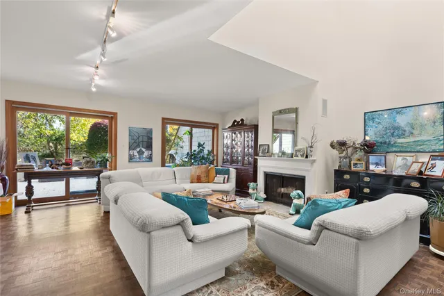 a living room with fireplace furniture and a large window