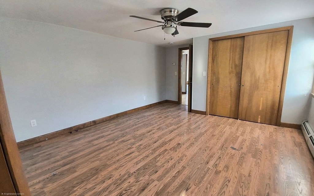 3 Warren Road, Unit B Oxford, MA 01537 - Photo 15 of 16 a view of empty room with wooden floor and fan