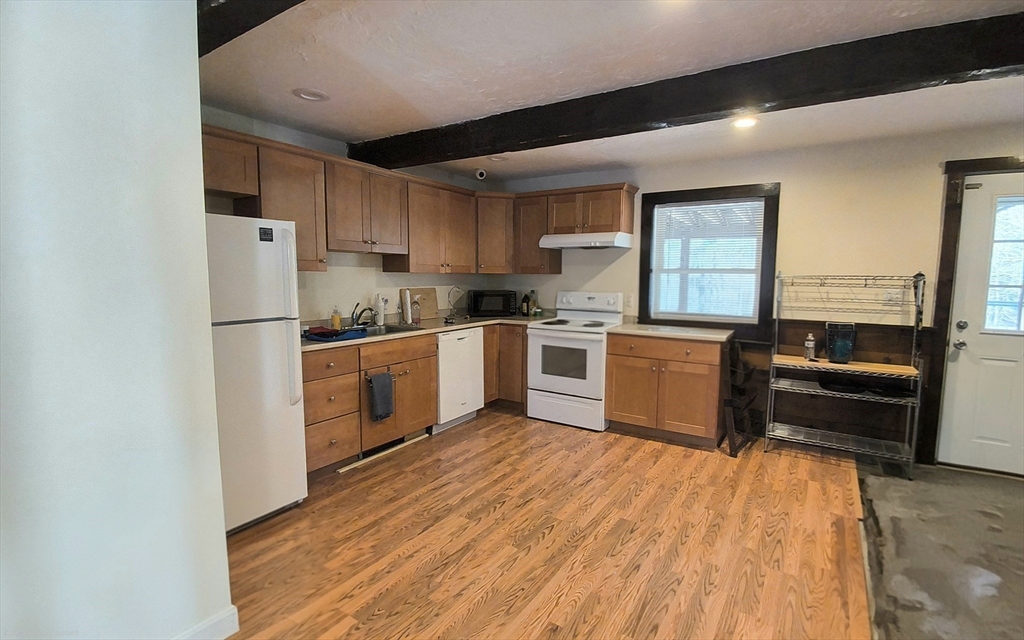 3 Warren Road, Unit B Oxford, MA 01537 - Photo 5 of 16 a kitchen with stainless steel appliances granite countertop a stove top oven a sink dishwasher and a refrigerator