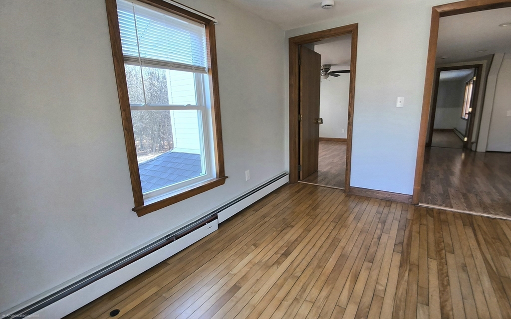 3 Warren Road, Unit B Oxford, MA 01537 - Photo 10 of 16 an empty room with wooden floor and windows