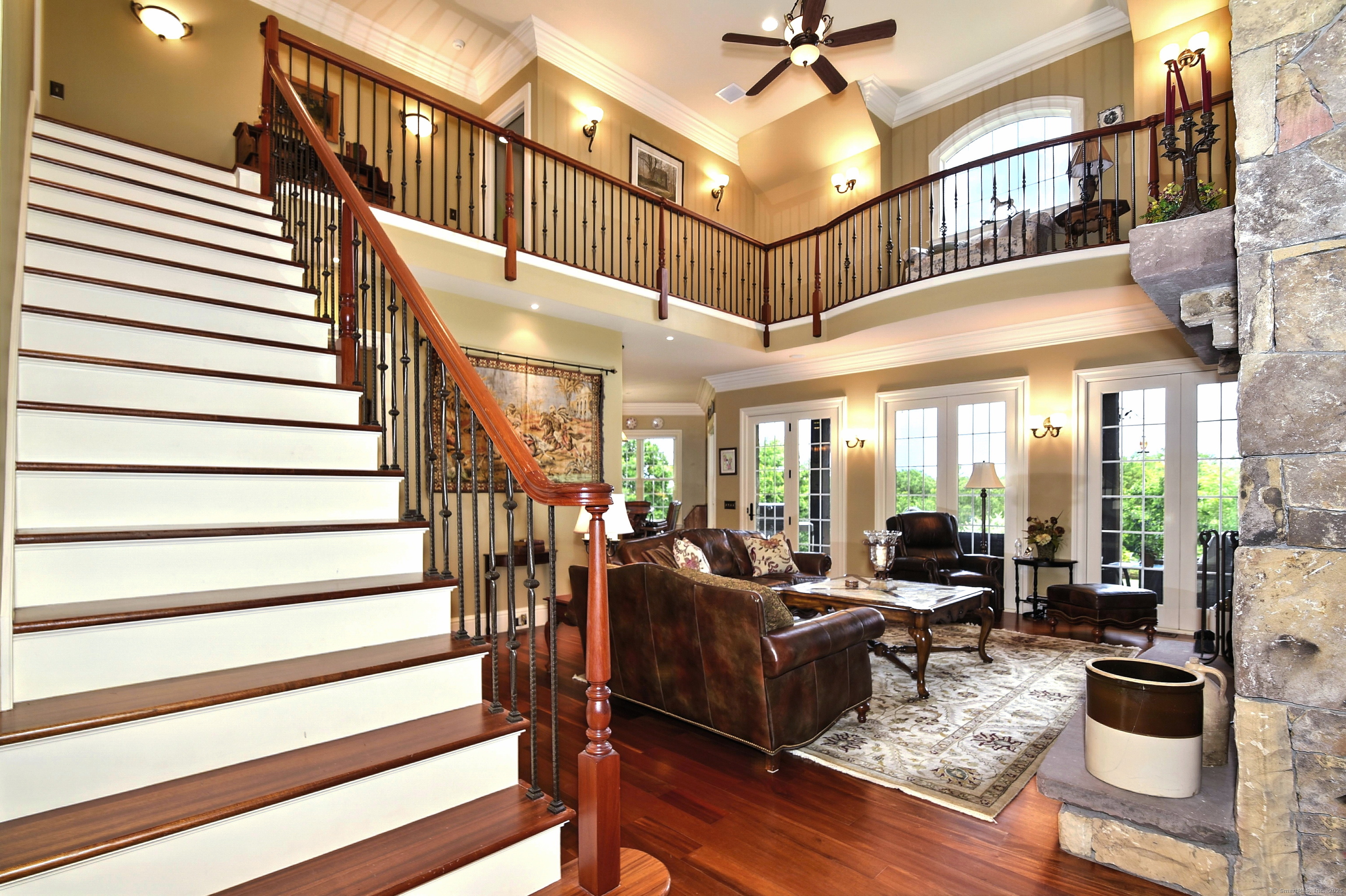 282 Searles Road Pomfret, CT 06259 - Photo 7 of 40 Soaring double-height ceiling. Iron balusters grace the grand mahogany staircase and upper bowed balcony.