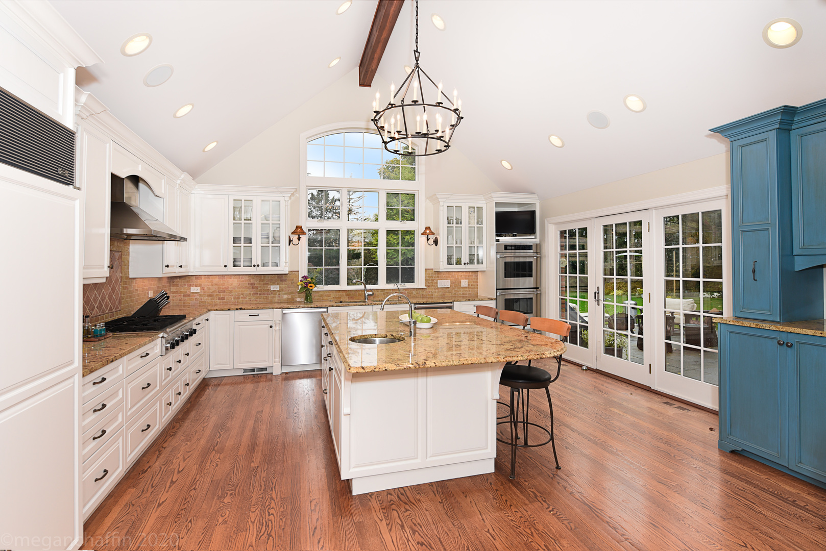 1115 Mohawk Road Wilmette, IL 60091 - Photo 5 of 66 a large kitchen with kitchen island a large counter space and stainless steel appliances