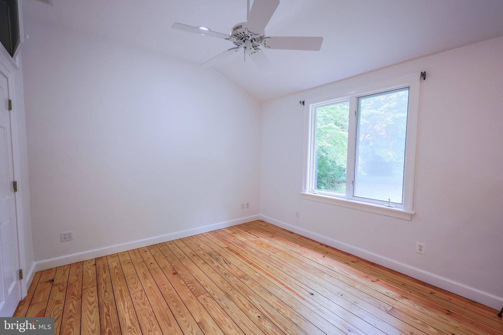 98 Swindler Hollow Road Sperryville, VA 22740 - Photo 9 of 25 wooden floor in an empty room with a window