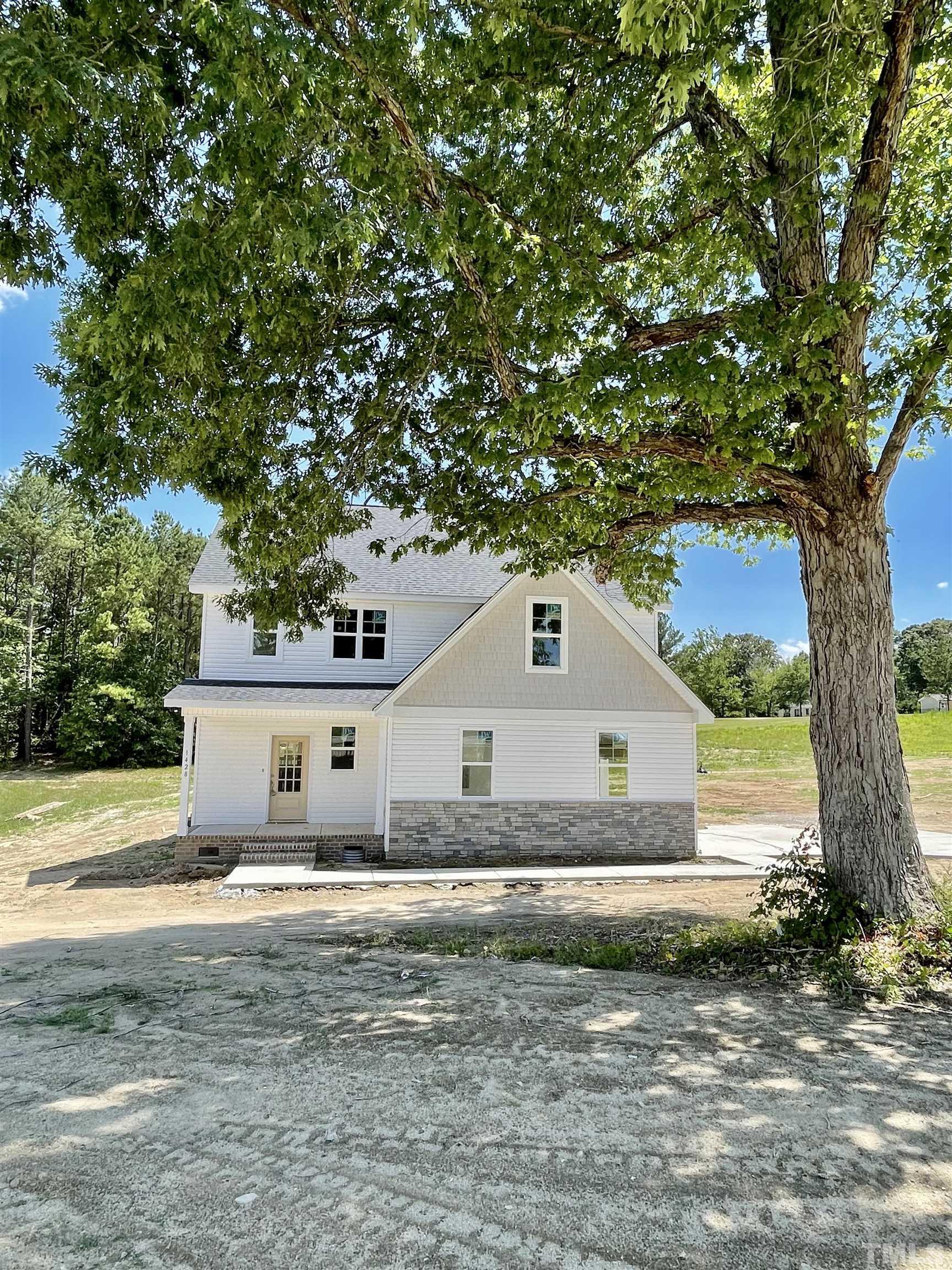 1428 Old Watkins Road Raleigh, NC 27616 - Photo 1 of 36 a front view of a house with a yard