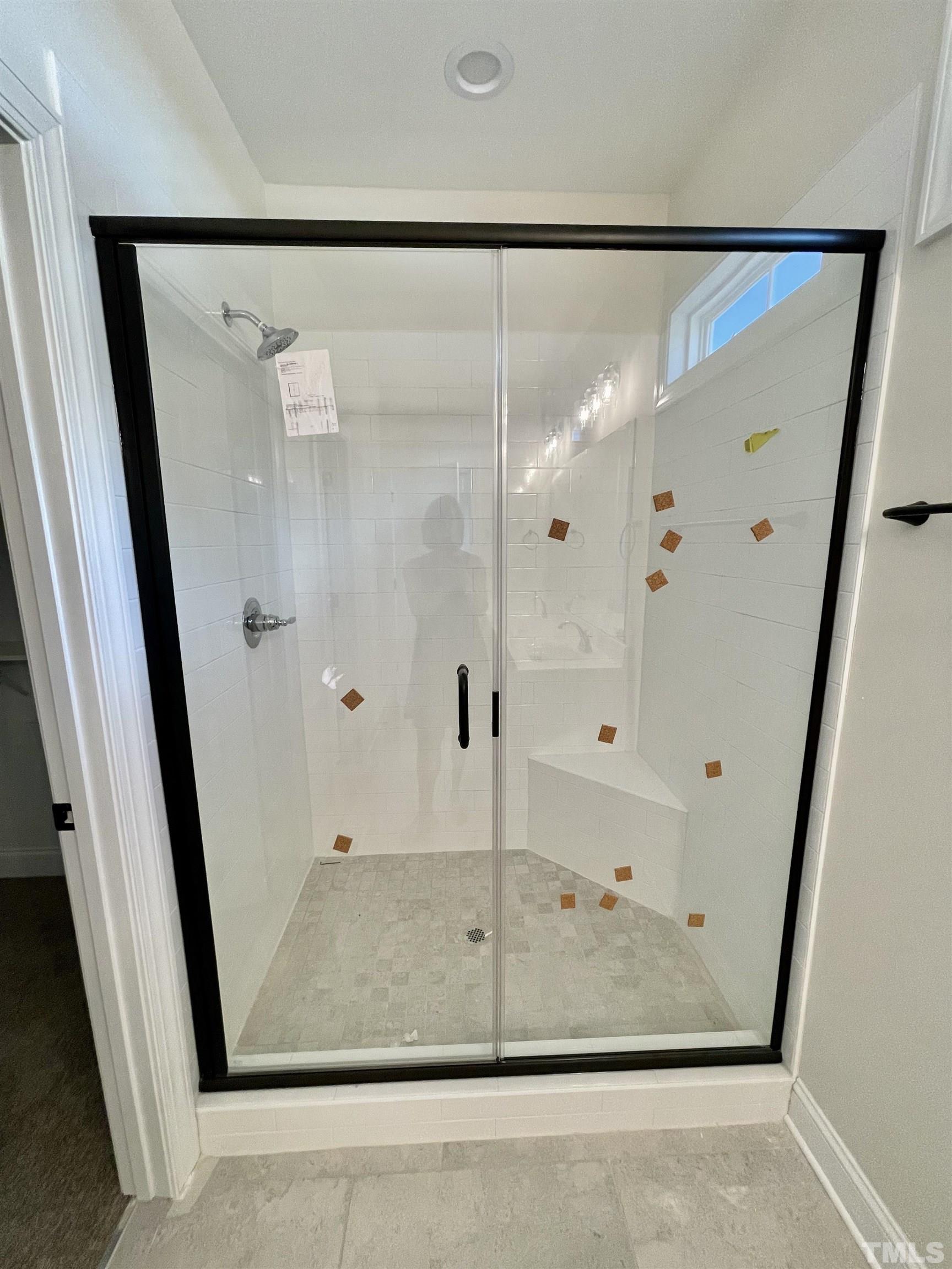1428 Old Watkins Road Raleigh, NC 27616 - Photo 19 of 36 a bathroom with a glass shower door and a glass door