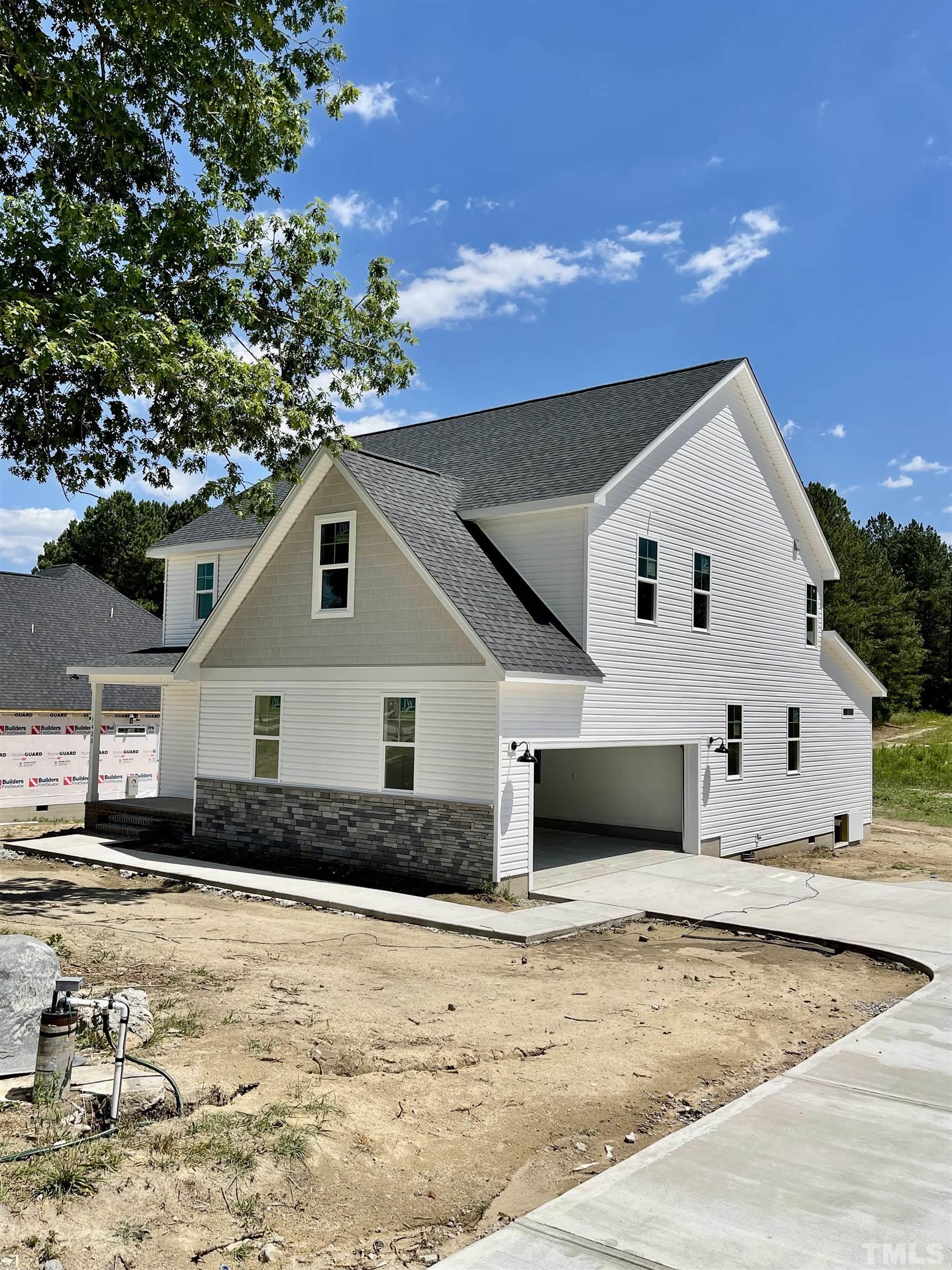 1428 Old Watkins Road Raleigh, NC 27616 - Photo 2 of 36 a front view of a house with a yard