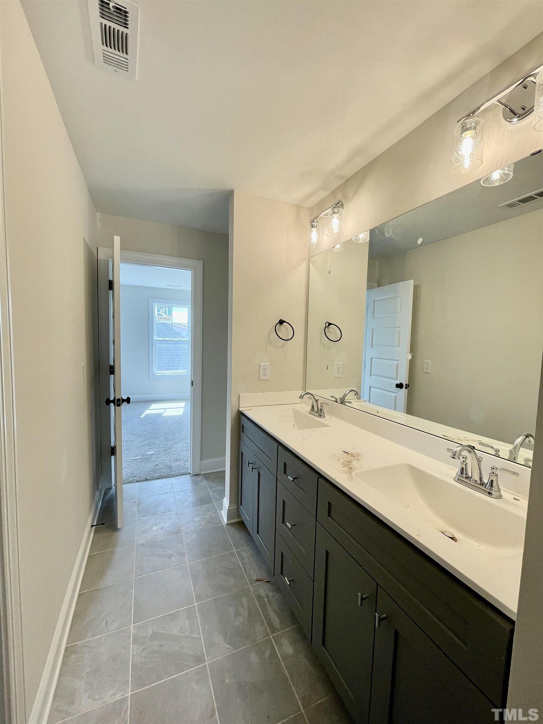 1428 Old Watkins Road Raleigh, NC 27616 - Photo 25 of 36 a spacious bathroom with a granite countertop sink mirror and a