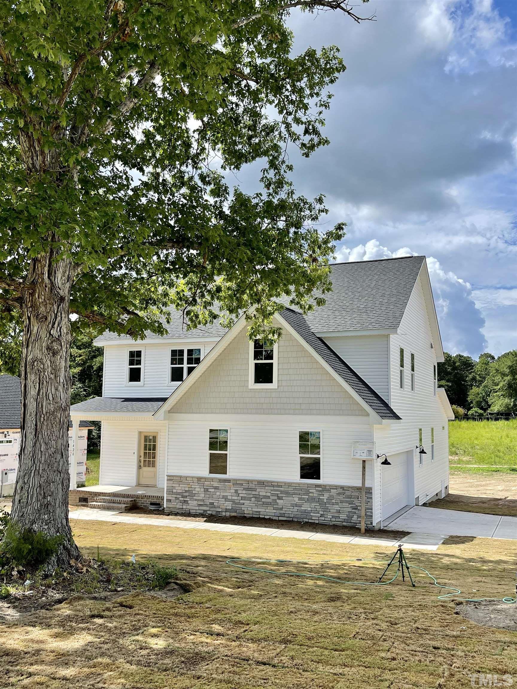 1428 Old Watkins Road Raleigh, NC 27616 - Photo 36 of 36 a front view of a house with a yard
