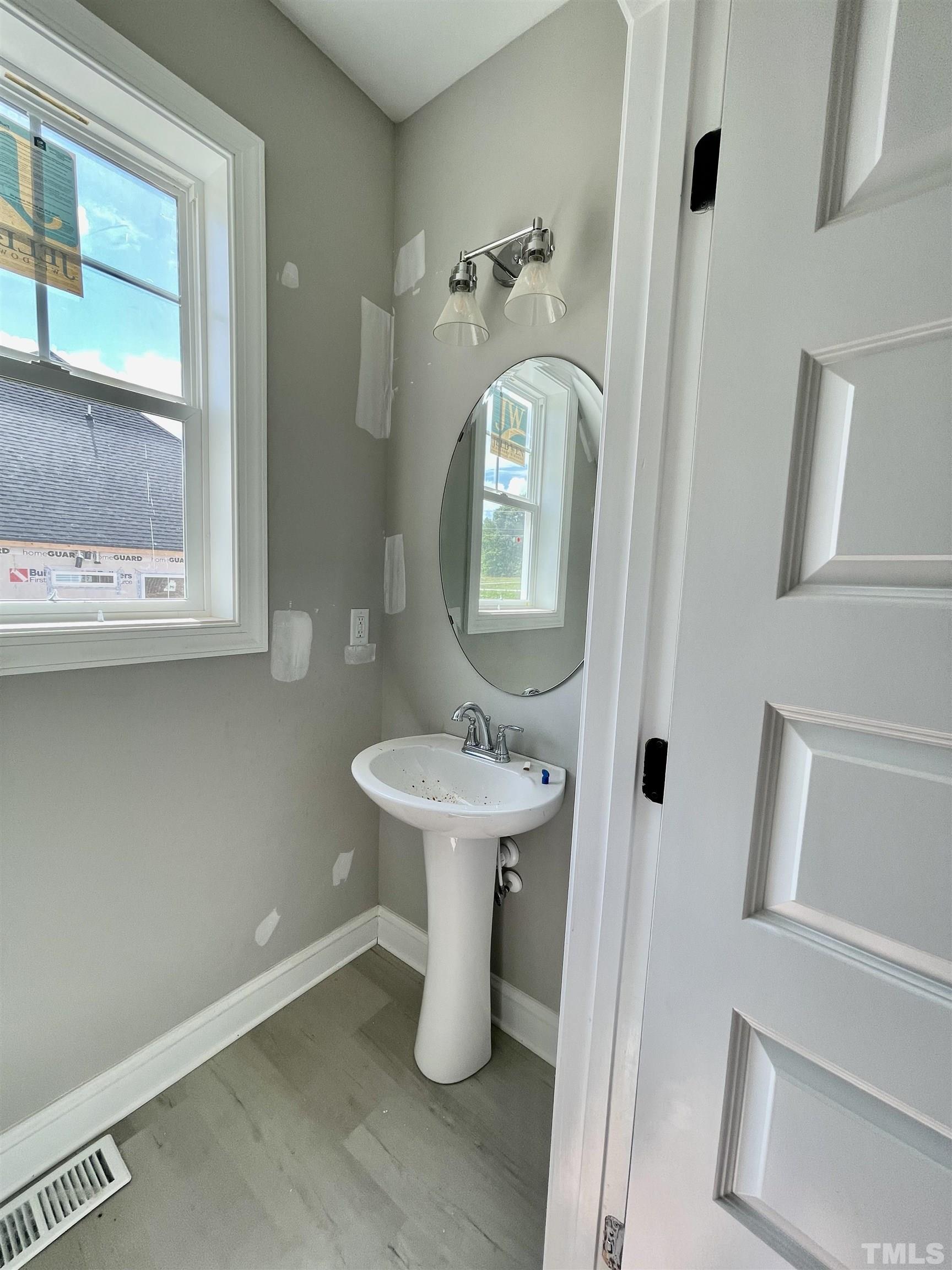 1428 Old Watkins Road Raleigh, NC 27616 - Photo 6 of 36 a bathroom with a sink a toilet and a mirror