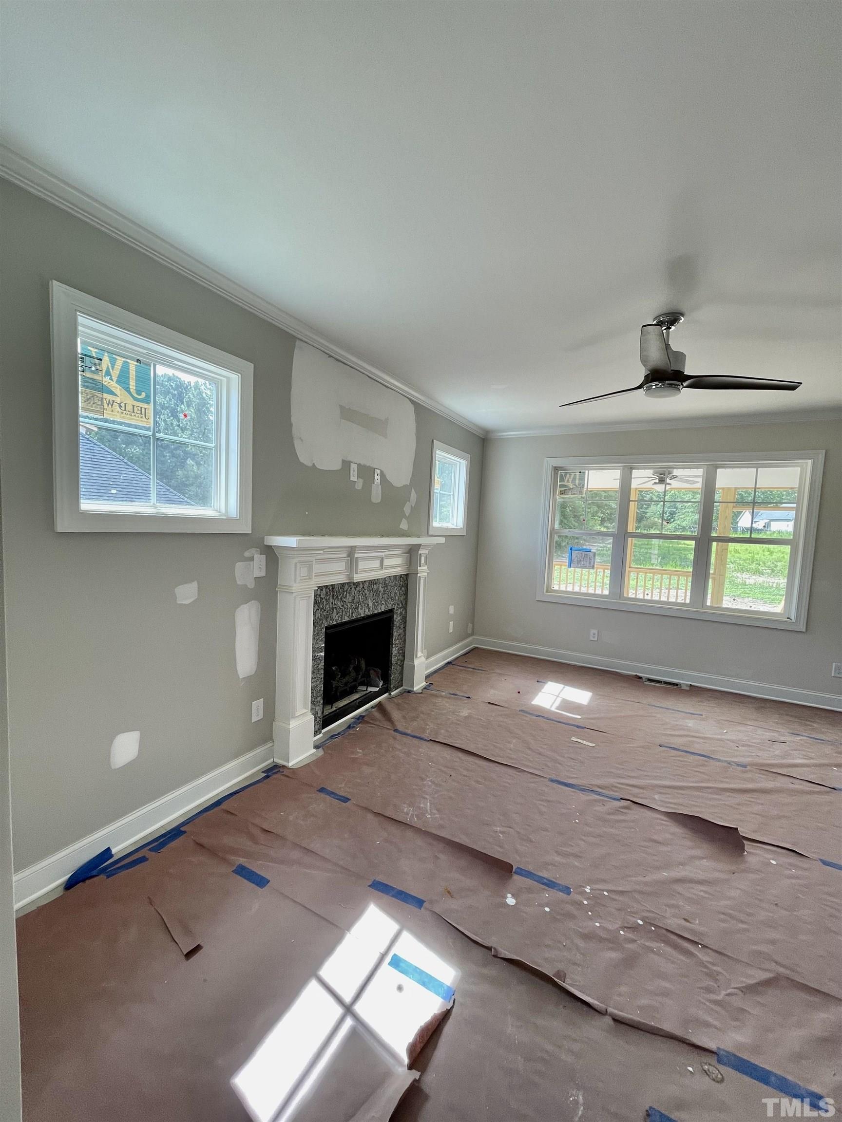 1428 Old Watkins Road Raleigh, NC 27616 - Photo 7 of 36 a view of an empty room with a window and fireplace