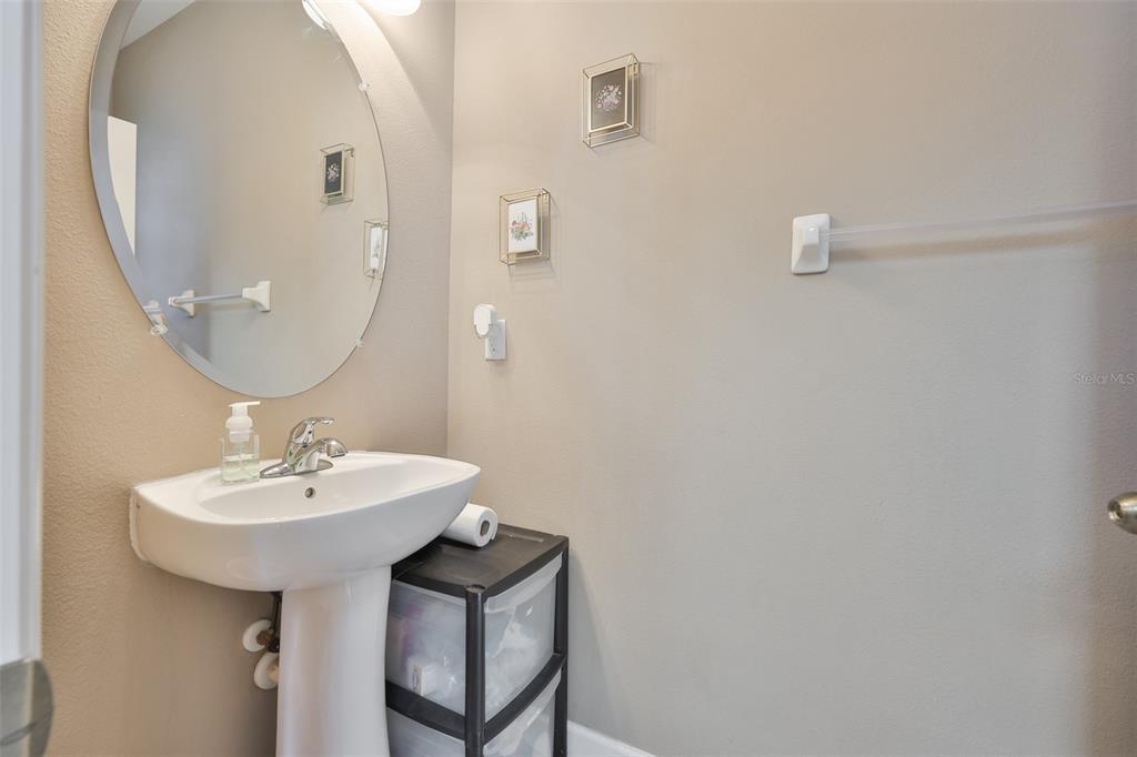 5779 Aaron Court Sarasota, FL 34232 - Photo 13 of 39 a bathroom with a sink a mirror and vanity