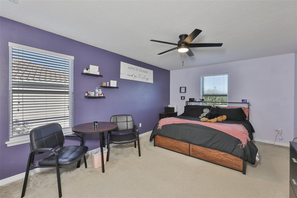 5779 Aaron Court Sarasota, FL 34232 - Photo 14 of 39 a bedroom with a bed work place and a desk