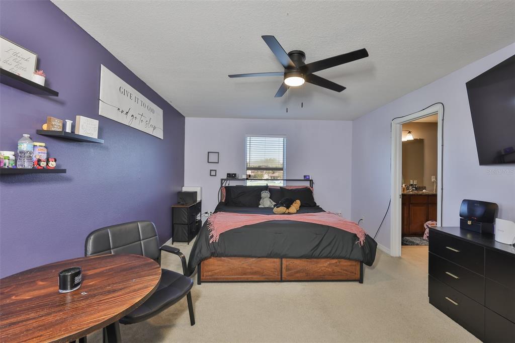 5779 Aaron Court Sarasota, FL 34232 - Photo 15 of 39 a bedroom with a bed and a flat screen tv