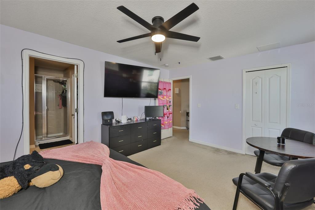 5779 Aaron Court Sarasota, FL 34232 - Photo 16 of 39 a bedroom with a bed and a flat screen tv