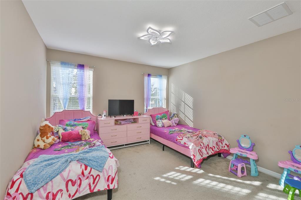 5779 Aaron Court Sarasota, FL 34232 - Photo 18 of 39 a bedroom with a bed and a chandelier