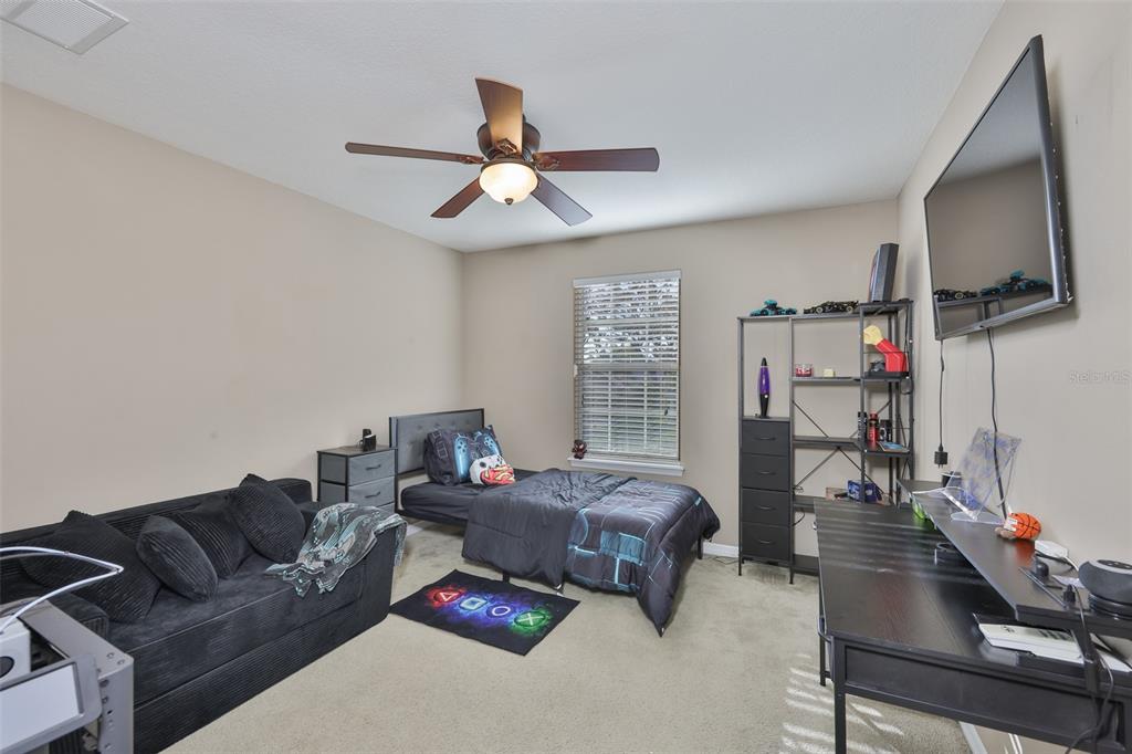 5779 Aaron Court Sarasota, FL 34232 - Photo 20 of 39 a living room with furniture a ceiling fan and a window