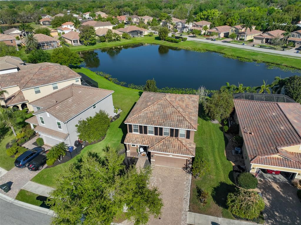 5779 Aaron Court Sarasota, FL 34232 - Photo 2 of 39 an aerial view of a house with a lake view