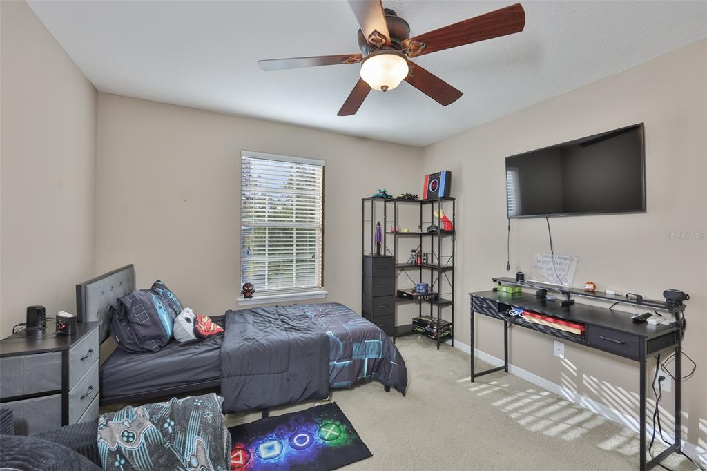 5779 Aaron Court Sarasota, FL 34232 - Photo 21 of 39 a living room with furniture a flat screen tv and a window