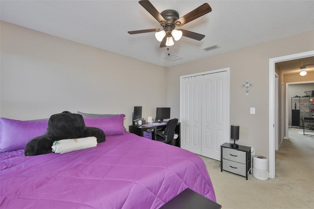 5779 Aaron Court Sarasota, FL 34232 - Photo 24 of 39 a bedroom with a bed and a chandelier