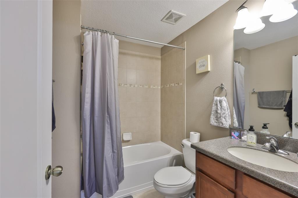 5779 Aaron Court Sarasota, FL 34232 - Photo 25 of 39 a bathroom with a granite countertop sink toilet and shower