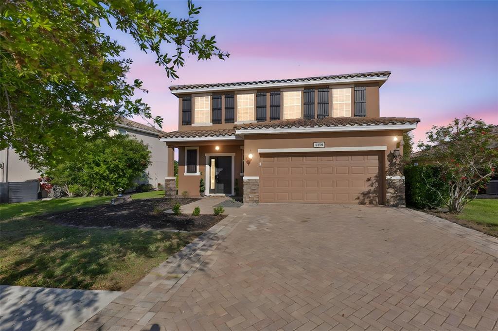 5779 Aaron Court Sarasota, FL 34232 - Photo 36 of 39 a front view of a house with a yard and garage