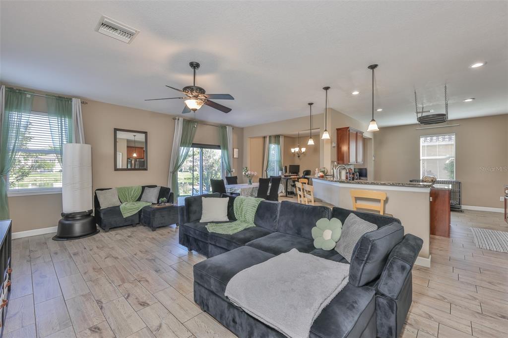 5779 Aaron Court Sarasota, FL 34232 - Photo 7 of 39 a living room with fireplace furniture and a wooden floor