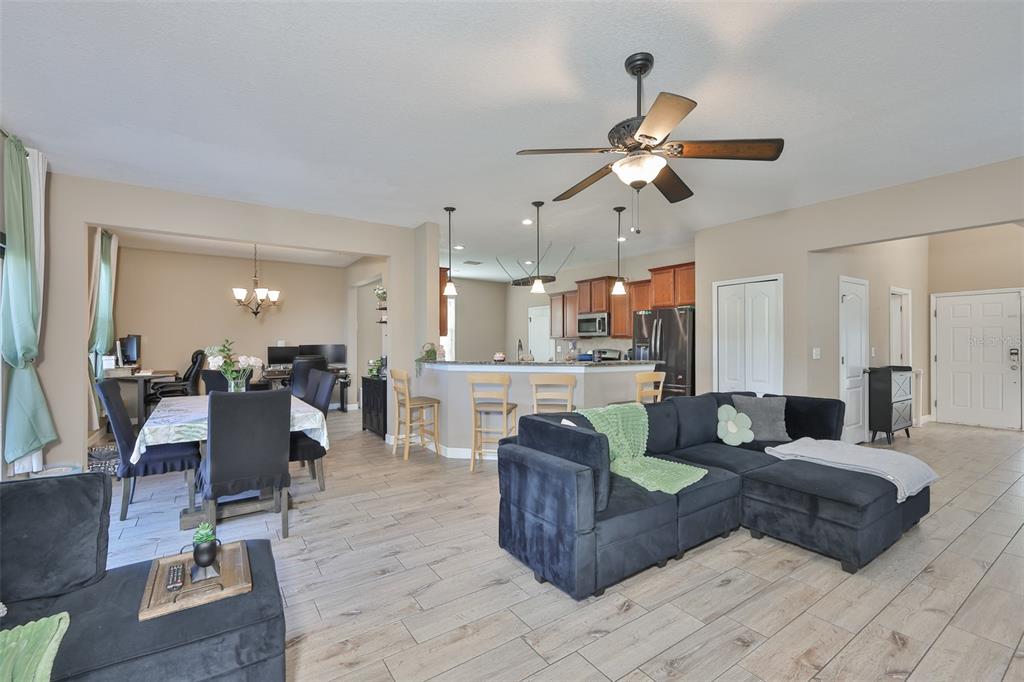 5779 Aaron Court Sarasota, FL 34232 - Photo 9 of 39 a living room with couches and kitchen view with wooden floor