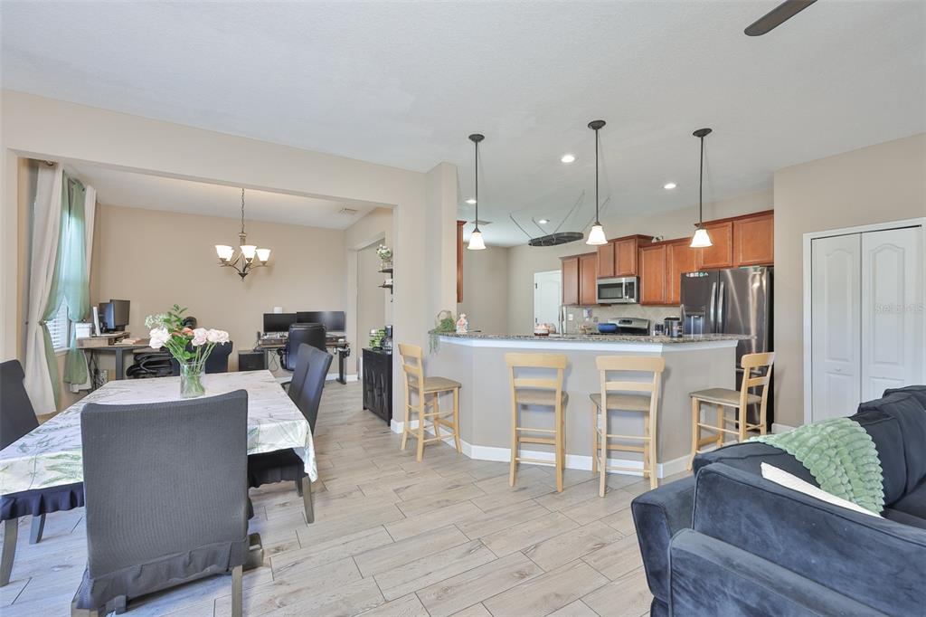 5779 Aaron Court Sarasota, FL 34232 - Photo 10 of 39 a view of kitchen with dining table chairs and wooden floor