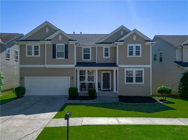 a front view of a house with a yard