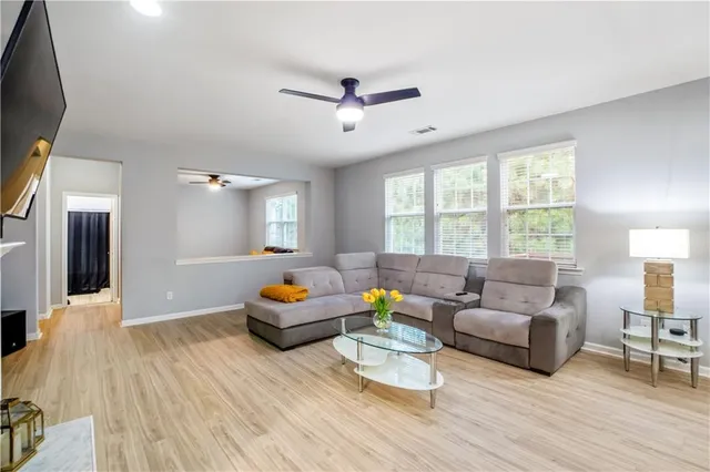 a spacious bedroom with a bed a couch and a window