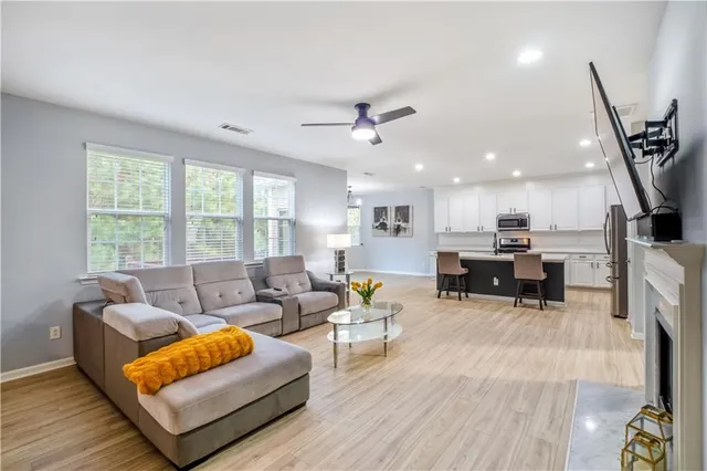 a living room with furniture a fireplace and a flat screen tv