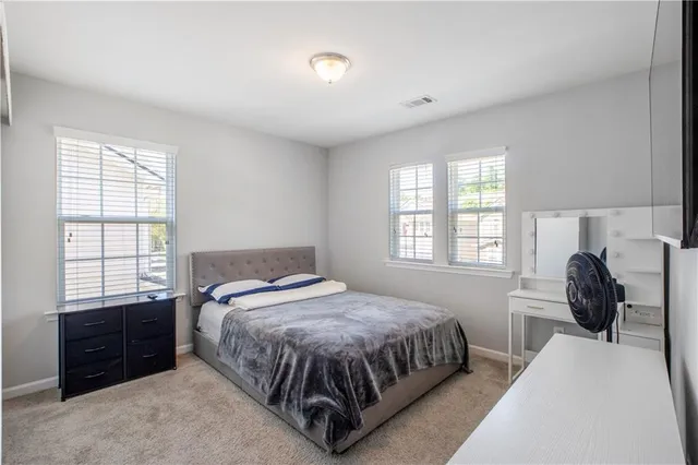 a bedroom with a bed and a tv