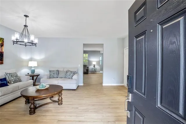 a kitchen with kitchen island a dining table chairs stainless steel appliances and cabinets