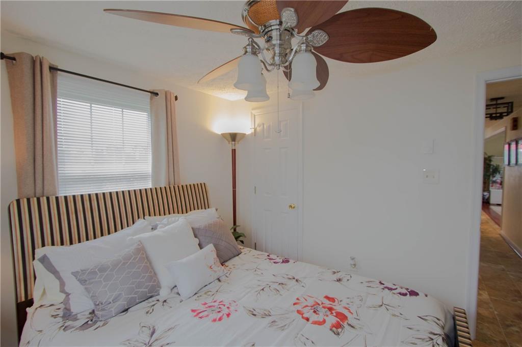 365 Whitehall Road Lancaster, VA 22503 - Photo 22 of 40 a bedroom with a bed and a chandelier