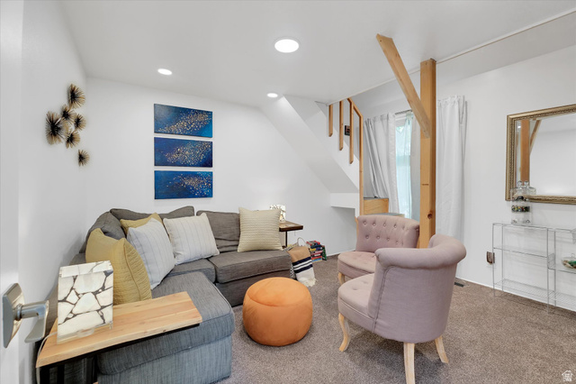 510 Spring Creek Road Providence, UT 84332 - Photo 17 of 97 Carpeted living space featuring recessed lighting, white walls, and an exposed wooden support beam
