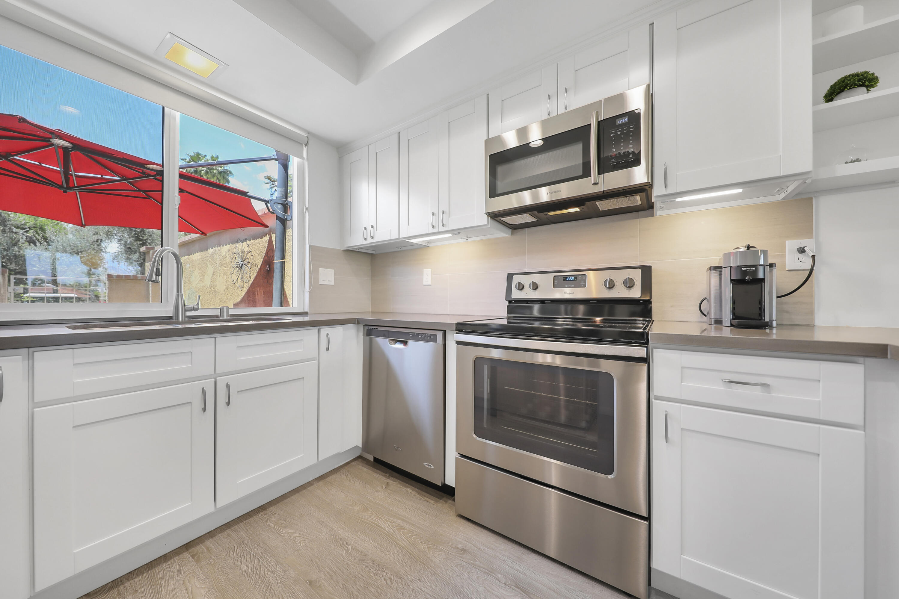 23 Haig Drive Rancho Mirage, CA 92270 - Photo 8 of 29 a kitchen with stainless steel appliances granite countertop a stove a microwave and a sink