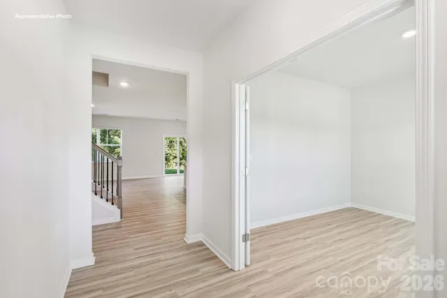 a view of a hallway view with wooden floor and staircase