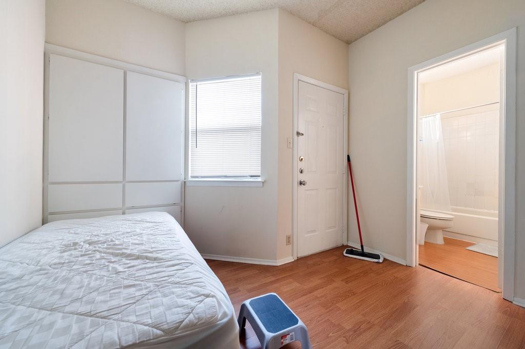 2604 Salado Street, Unit 302 Austin, TX 78705 - Photo 11 of 15 a bedroom with a bed and a window